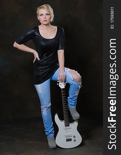 Images showing pretty young female with white electric guitar. Images showing pretty young female with white electric guitar