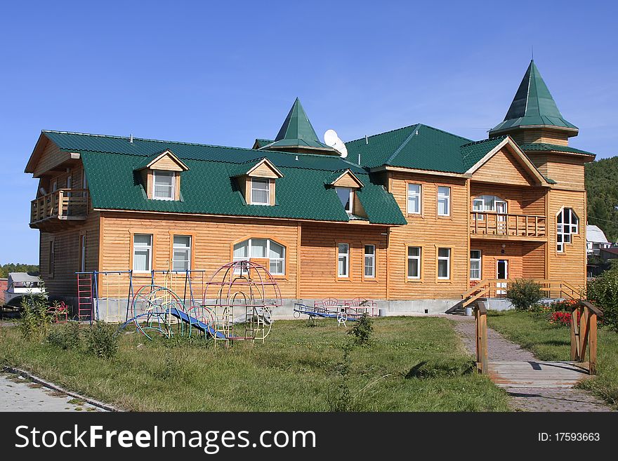 Wooden house in village on background blue sky