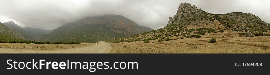 Panoramic view of Rif Mountains with a cloudy sky near Oued Laou, Chefchaouen, Morocco. Panoramic view of Rif Mountains with a cloudy sky near Oued Laou, Chefchaouen, Morocco