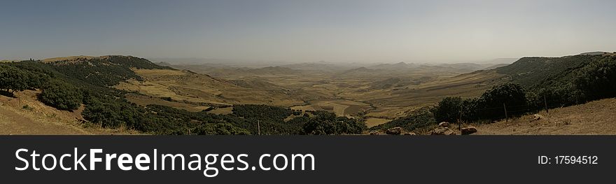 Panoramic view of Paysage D'Ito, a volcanic plateau littered with dark pumice rock in Middle Atlas, near Azrou, Morocco. Panoramic view of Paysage D'Ito, a volcanic plateau littered with dark pumice rock in Middle Atlas, near Azrou, Morocco