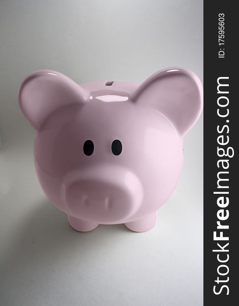 Pink piggy bank with white background.