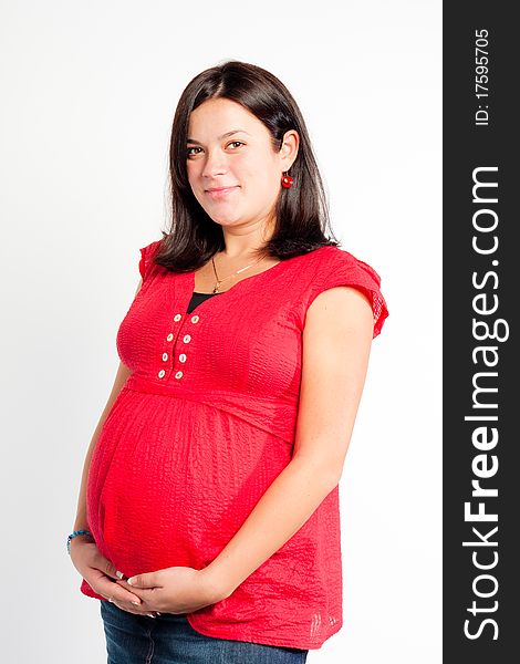 Beautiful pregnant woman staing on light grey background