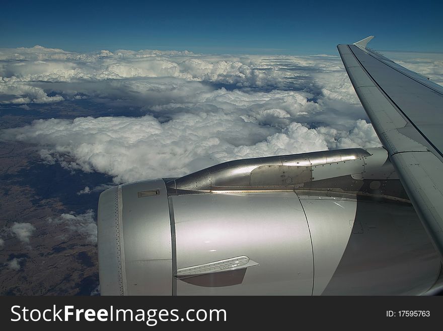 Aircraft engine and wing in sky