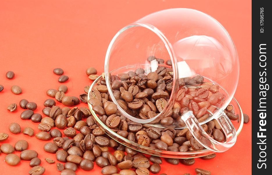 Glass cup with coffee beans around