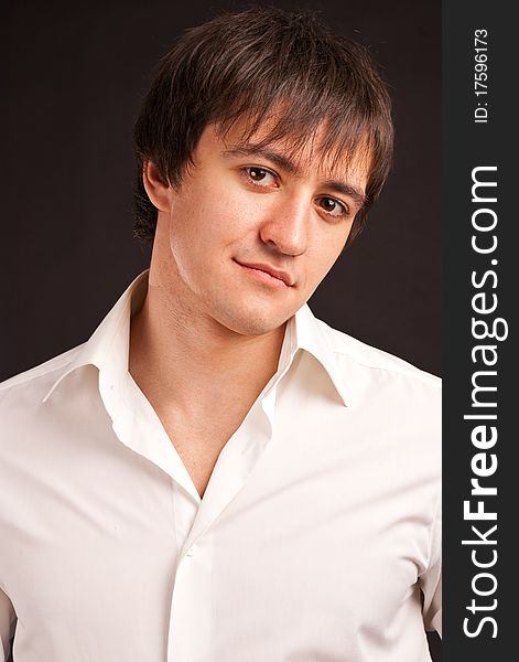 Portrait adult guy on black backdrop