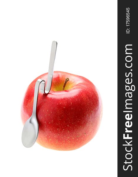Apple and spoon on a white