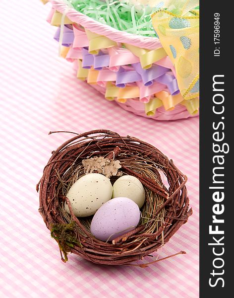 Easter Painted Colorful eggs in birds nest for sunday morning on a pastel color background. Easter Painted Colorful eggs in birds nest for sunday morning on a pastel color background