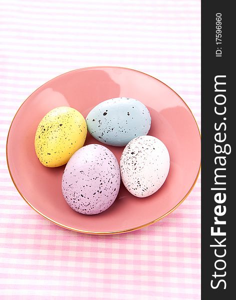 Easter Painted Colorful eggs on a saucer for sunday morning on a pastel color background