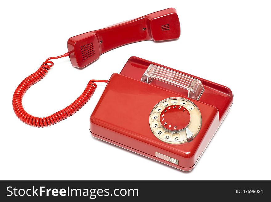 Classic, red, corded telephone with faded dialplate. Classic, red, corded telephone with faded dialplate