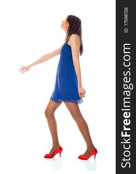 Young woman with blue dress and red shoes on a white background