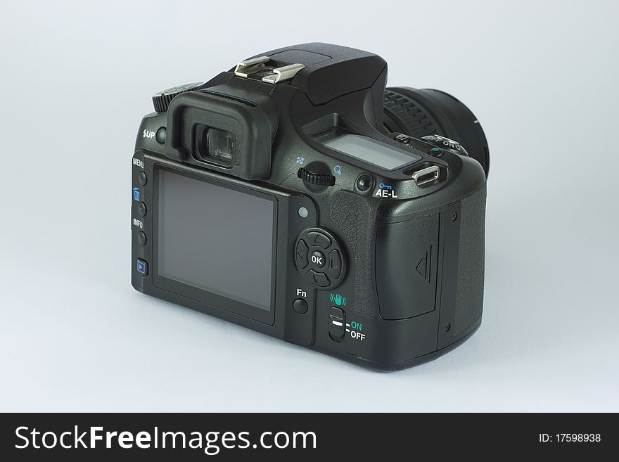 Black photo camera isolated in white