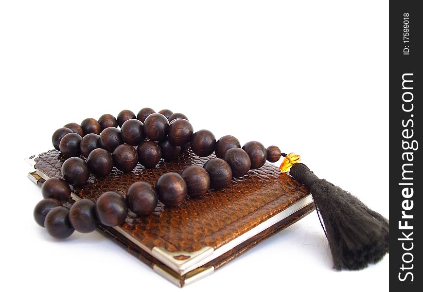 Note pad overhand wooden rosary beads on white background. Note pad overhand wooden rosary beads on white background