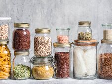 Glass Jars With Various Cereals And Seeds - Peas Split, Sunflower And Pumpkin Seeds, Beans, Rice, Pasta, Oatmeal, Lentils, Bulgur Royalty Free Stock Image