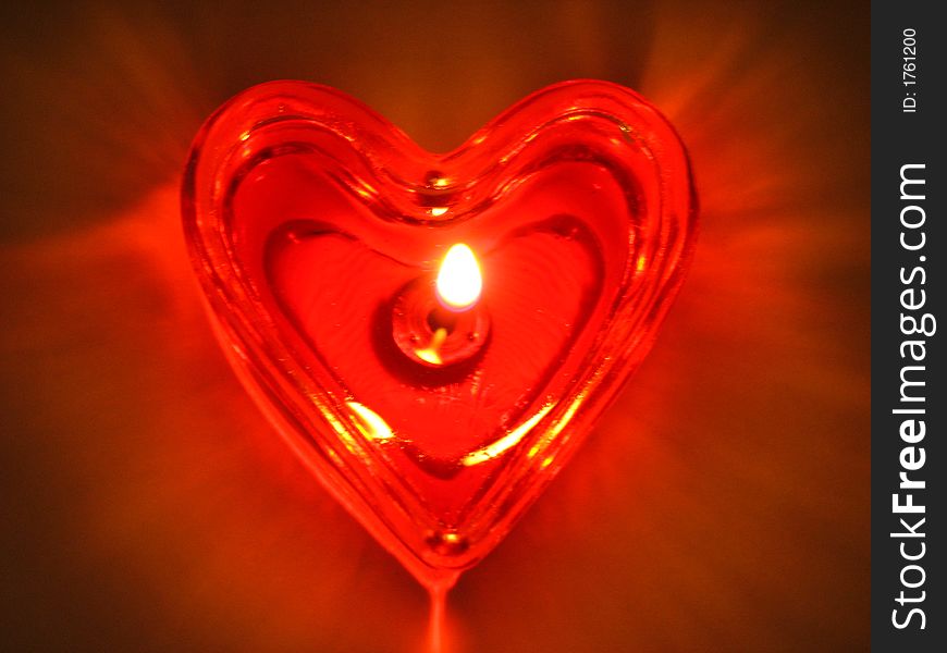 Burning heart. Burning candle in the form of the heart.