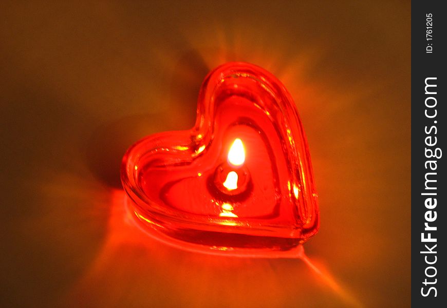 Burning heart. Burning candle in the form of the heart.