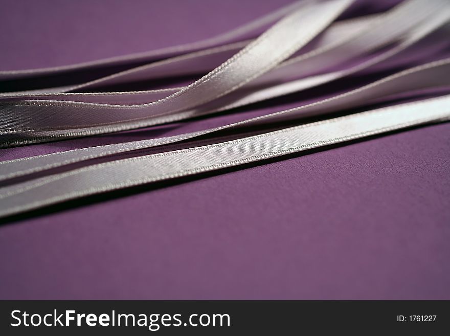Satin ribbons on violet for background