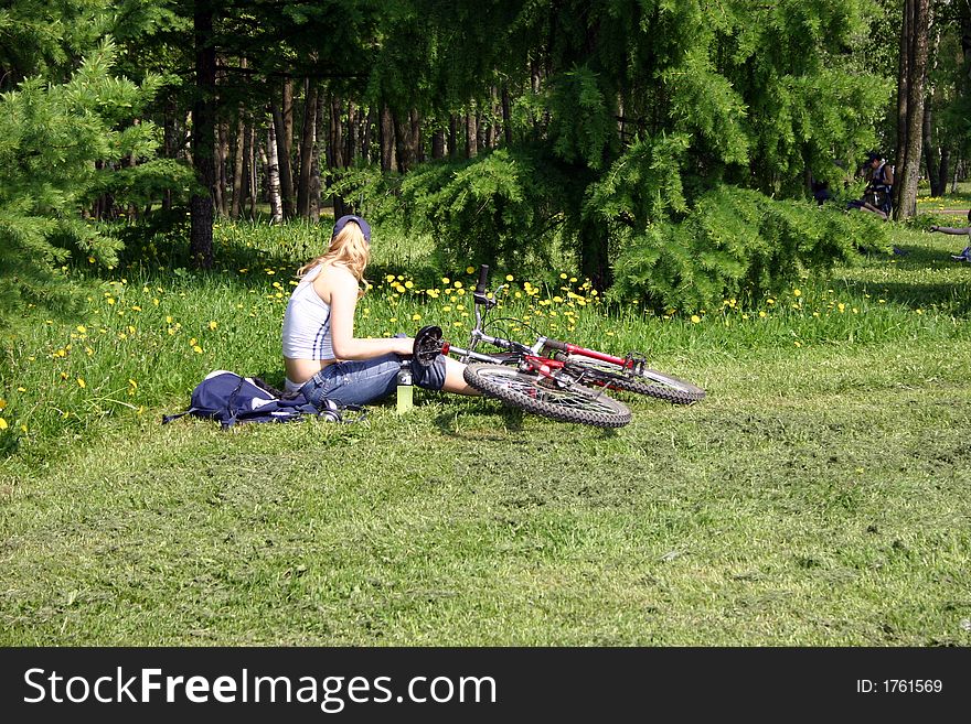 Girl with bicycle in the park. Girl with bicycle in the park.