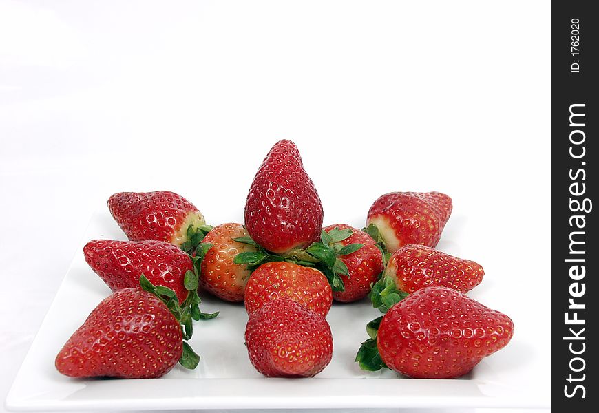 Some strawberry on a platter in white background