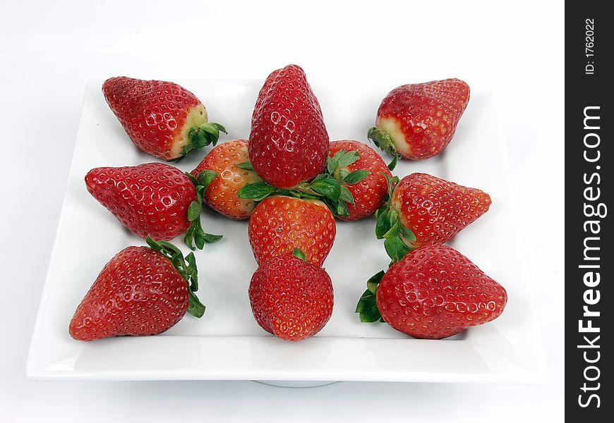 Some strawberryon a platter  on white background