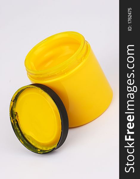 Yellow finger paint in a plastic jar