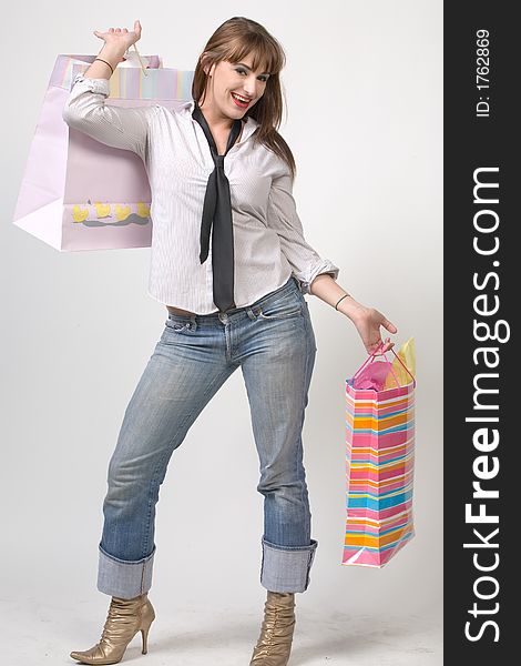 Cute Girl with shopping bags over grey background