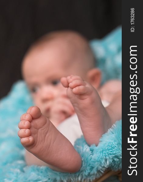 Image of baby boy nestled in a basket. Image of baby boy nestled in a basket