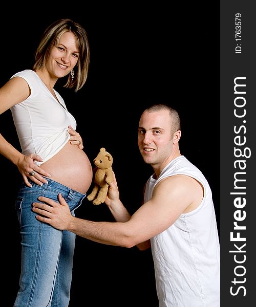 Couple with their teddy bear looking at camera. Couple with their teddy bear looking at camera