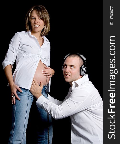 Young future parents listening to the womb