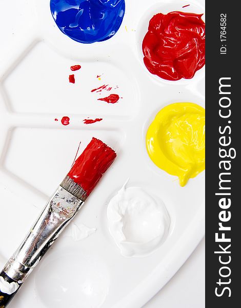 Paintbrush and palette on white background