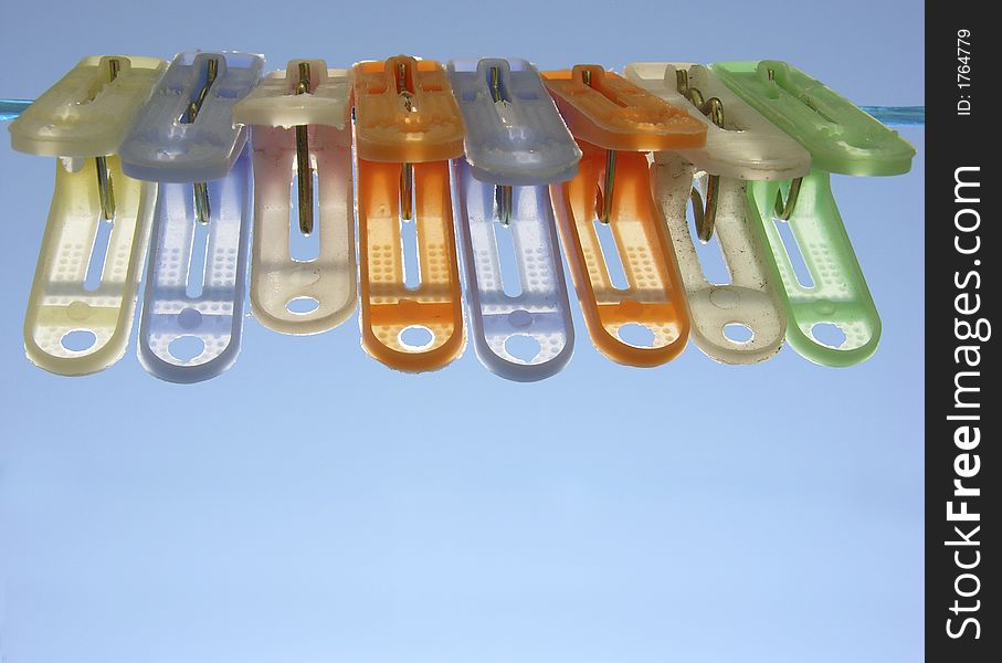 Colored plastic clothespins on wire