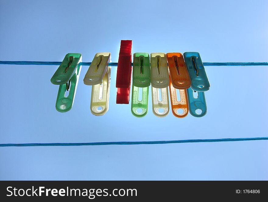 Plastic clothespins on a wire