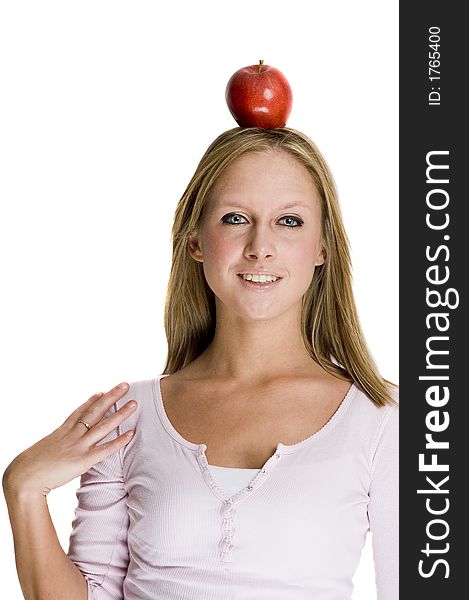 Pretty girl has put a red apple on top of her head