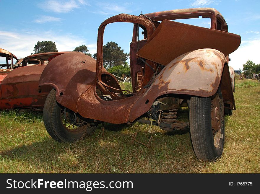 A car that has been left to rust. A car that has been left to rust