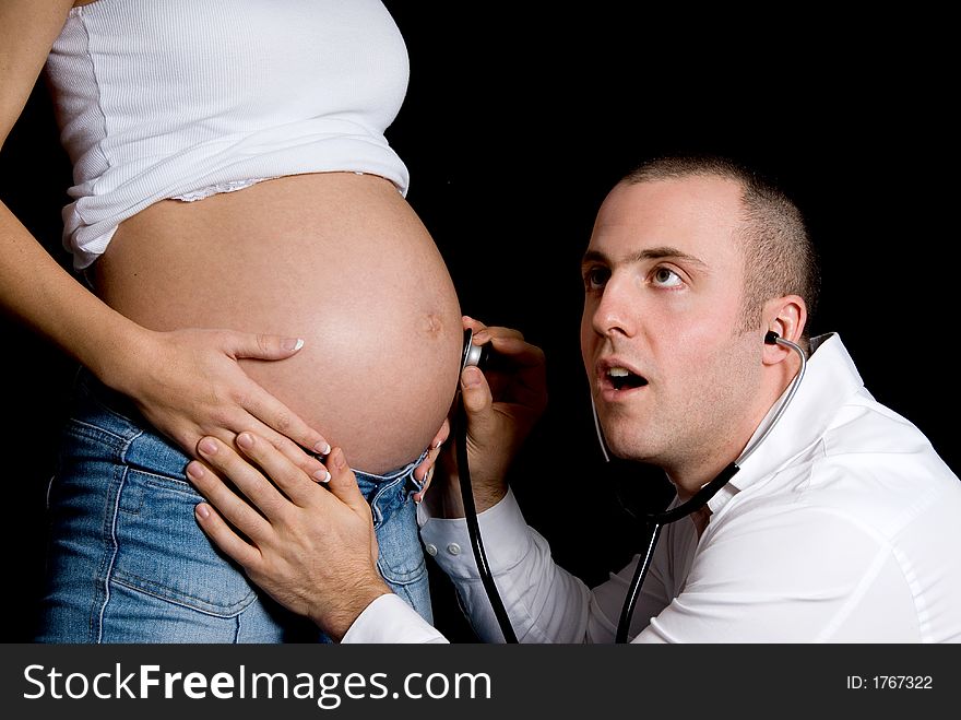 Future father listening to the baby's heart beat. Future father listening to the baby's heart beat