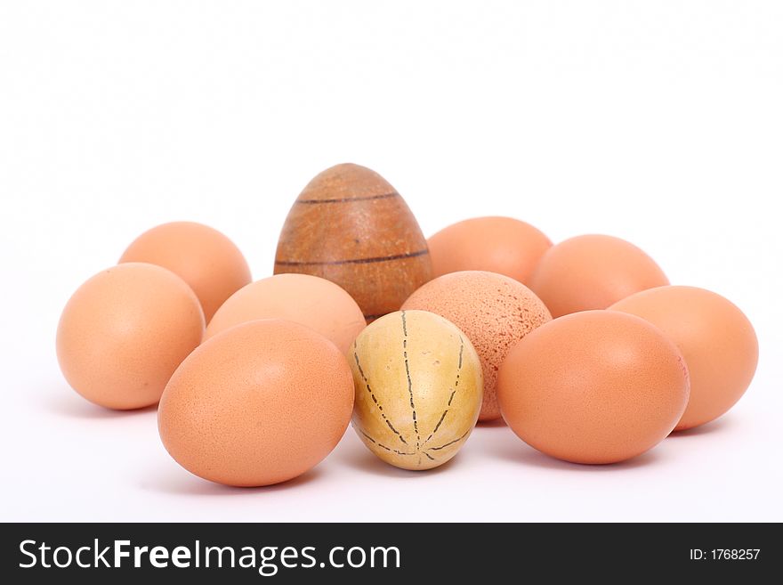 Brown eggs and two wooden eggs