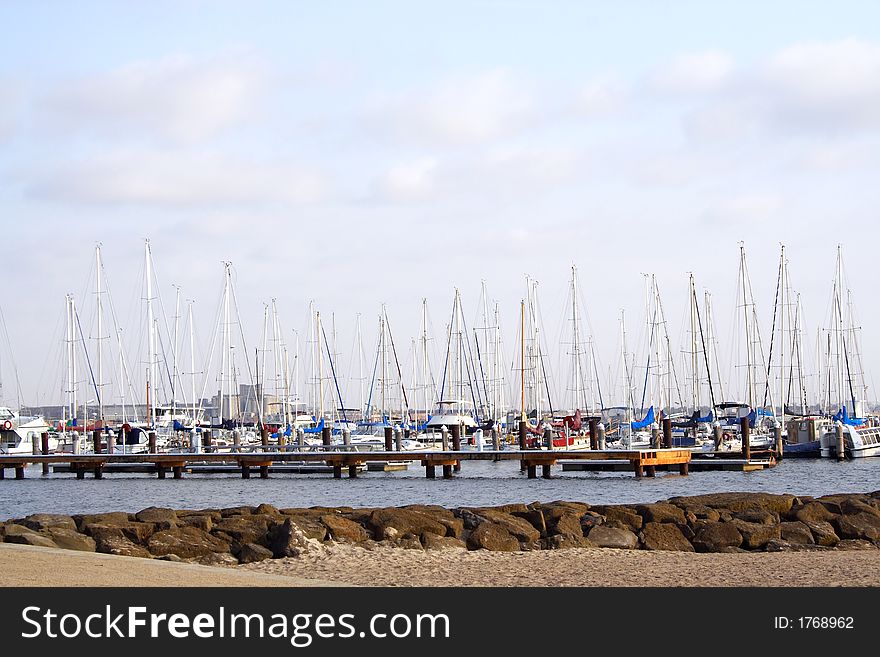 Yachts and boats parked at dock pier