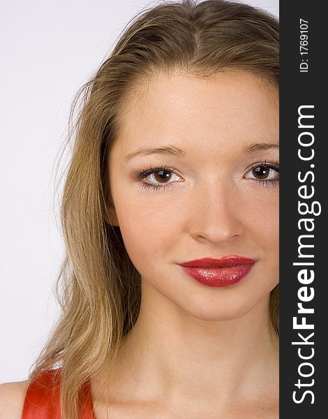 Closeup of female face. Red lipstick and red dress. Closeup of female face. Red lipstick and red dress.