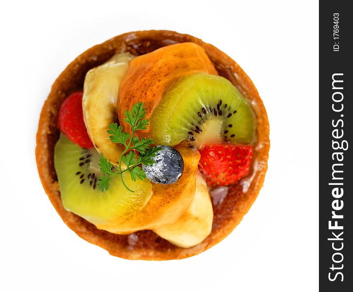 Upper view of a small tasty fruits tart over white background