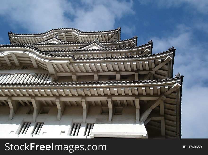 A photo of Himeji Castle's (also known as White Castle) beautiful roof and the sky above it. A photo of Himeji Castle's (also known as White Castle) beautiful roof and the sky above it