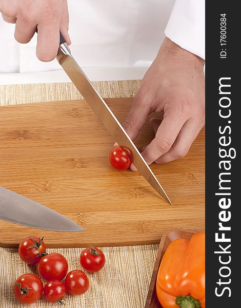 Chef Man cut vegetables on kitchen blackboard.