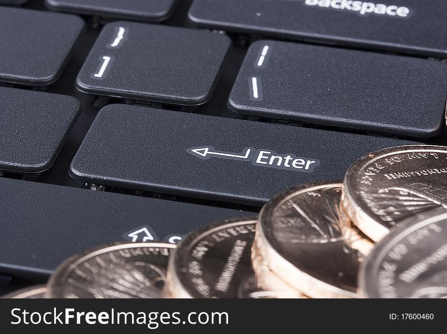 Keyboard laptop with coins in denominations of one dollar. Keyboard laptop with coins in denominations of one dollar.