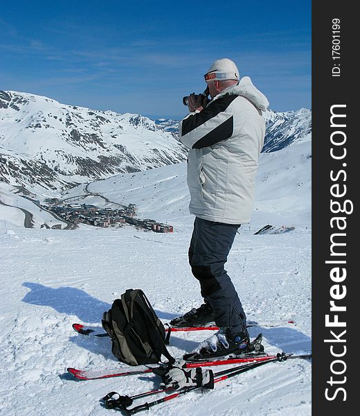 The man on skis with a camera at ski resort