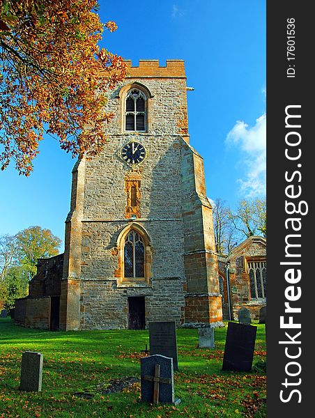 Yelvertoft Church Clock Tower through Autumn Leaves, Yelvertoft, Northamptonshire, England.  The Church at Yelvertoft was one that was ransacked by Oliver Cromwell's army, but survived as a good example of the use of Northamptonsire Stone. Yelvertoft Church Clock Tower through Autumn Leaves, Yelvertoft, Northamptonshire, England.  The Church at Yelvertoft was one that was ransacked by Oliver Cromwell's army, but survived as a good example of the use of Northamptonsire Stone.