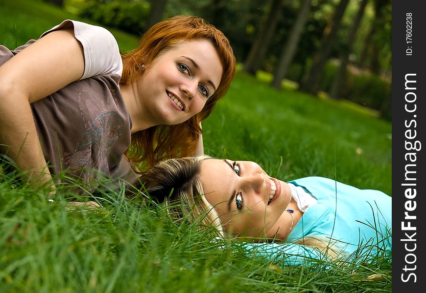 Two friends having a good time resting on the grass. Two friends having a good time resting on the grass