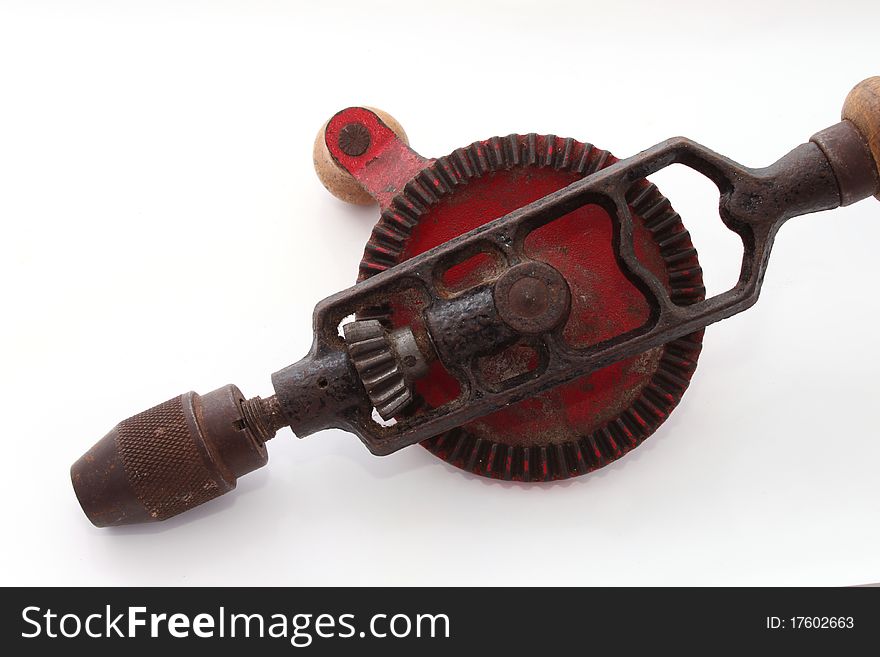 Old hand drill on a plain white background.