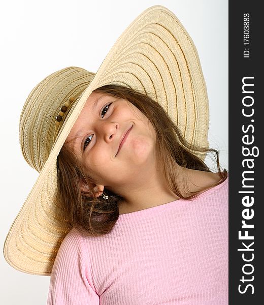 Portrait of little girl with brown eyes wearing straw hat on white. Portrait of little girl with brown eyes wearing straw hat on white