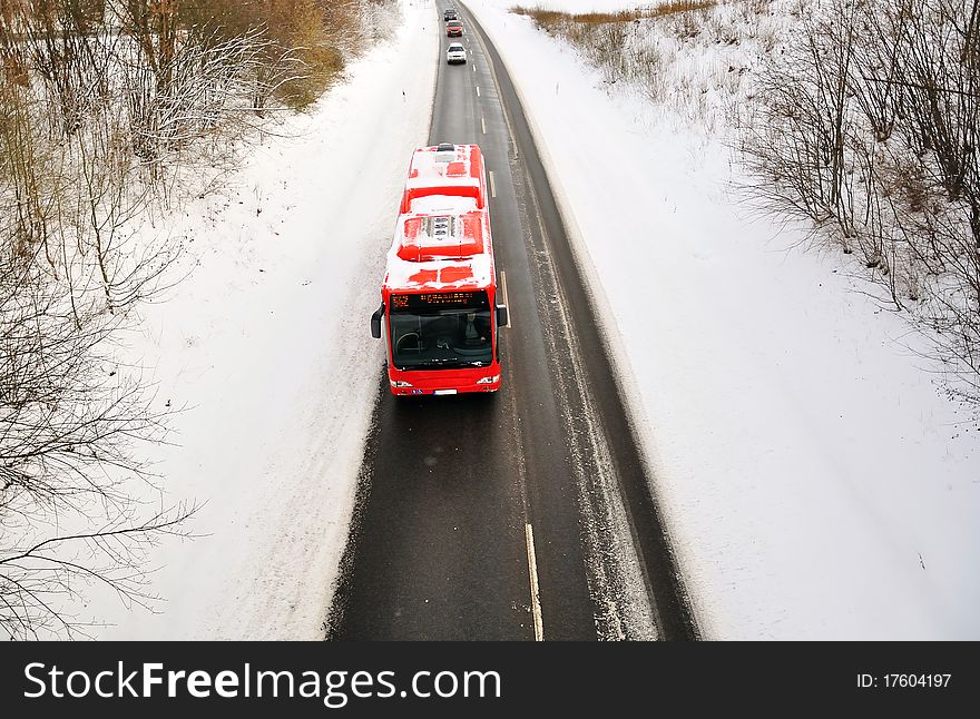 Red bus driving at winter weather. Red bus driving at winter weather.