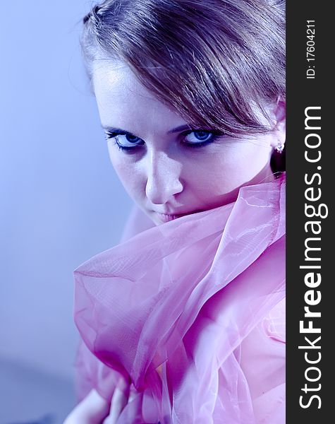 Portrait of a beautiful girl in the blue tones with a pink cloth. Portrait of a beautiful girl in the blue tones with a pink cloth