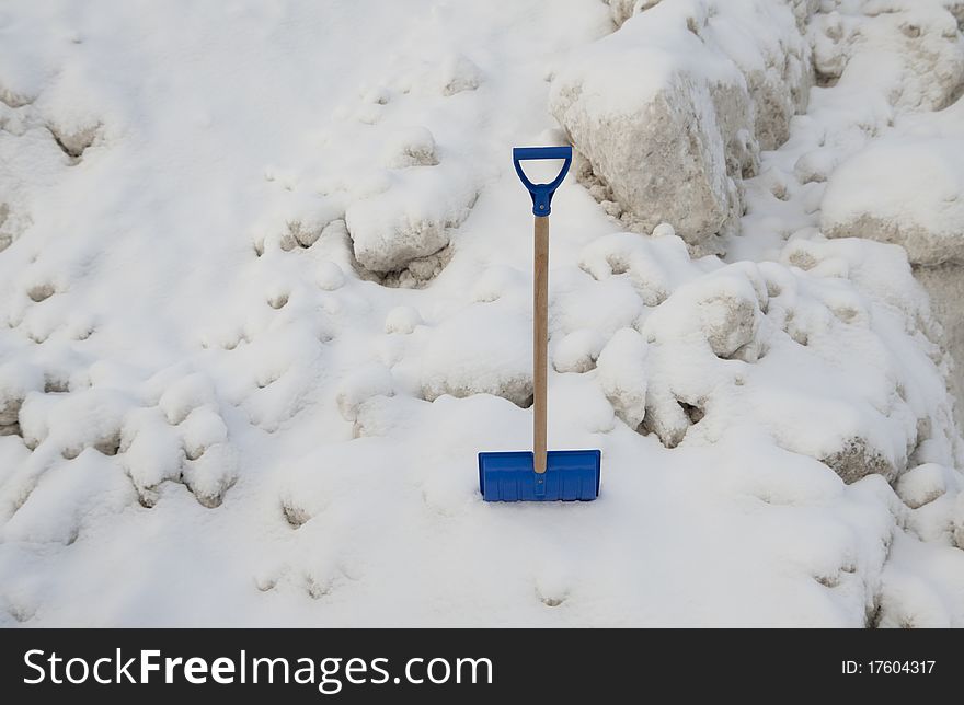 Blue plastic shovel on a snow background. Blue plastic shovel on a snow background