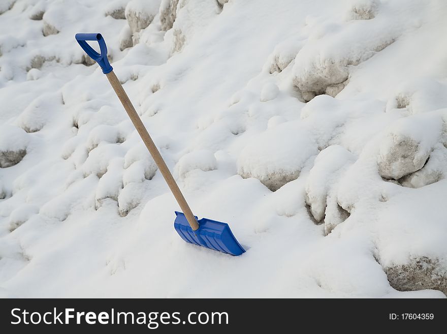 Blue plastic shovel on a snow background. Blue plastic shovel on a snow background